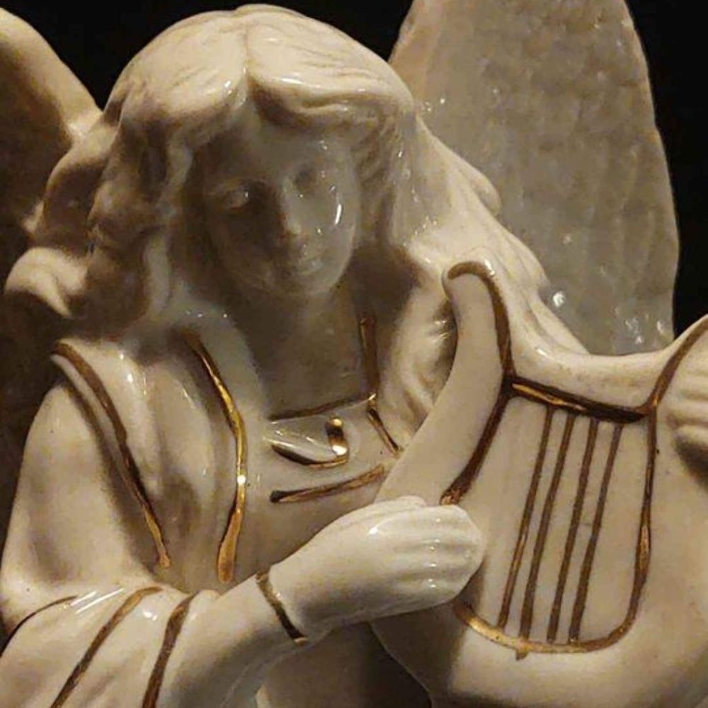 White Angel with Gold Metallic Accents Holding a Harp Rotating Music Box